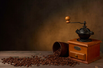 coffee grinder and clay cup on wooden table