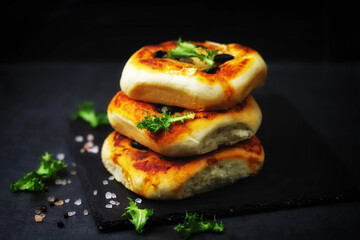 Mini pizzas in a column. Appetizing mini pizza presentation on a stone board. Healthy food.