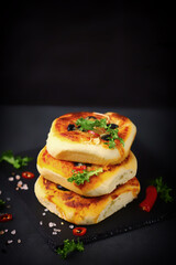 Mini pizzas in a column. Appetizing mini pizza presentation on a stone board. Healthy food.