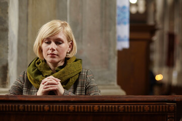 Young woman praying in a church