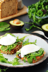 Homemade sandwiches with salmon, avocado and poached eggs