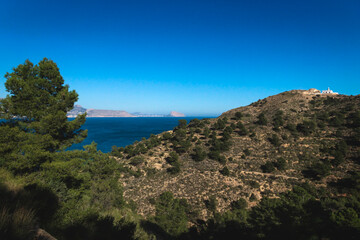 Fototapeta na wymiar Panorama view of natural park 'Serra Gelada' with lighthouse and the Rock 'Ifach' of Calpe in the background, Albir, Costa Blanca, Spain