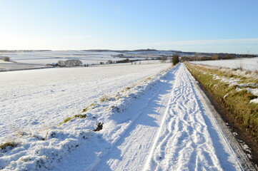 Fototapeta na wymiar Snow covers fields surrounding St Andrews, Scotland,, 8 January 2021