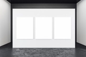 Modern concrete exhibition interior with three blank banners
