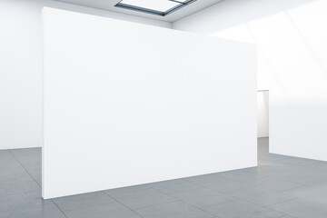 Modern gallery interior with empty white wall.