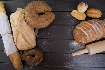 Homemade crusty bread cooking on blackboard background. Top view with space for your text