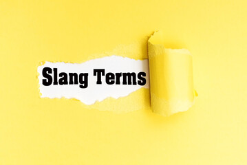 English phrase Slang Terms written on torn yellow paper.