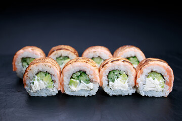 Grilled salmon sushi rolls, food background