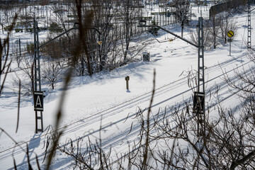 SNOWY, CATENARY AND SIGNALING AREAS OF A TRAIN TRACK