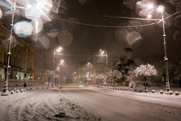 Winter townscape in a snowfall in a night street light, Bucharest.