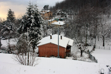 isolated village in the mountains in the Apuan Alps submerged in the white fairy snow of winter