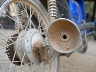 closeup of old motorcycle exhaust system.
