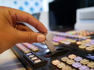 hand on dissolve of switcher buttons in studio TV station,Television Broadcast.