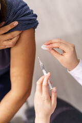 Vaccination healthcare concept - Hands of doctor or nurse hold a syringe and ampule preparing a...