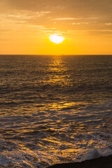 Fototapeta na wymiar Beautiful sunset in Lima Peru, bright sky and underexposed beach, golden hour, orange sky