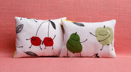 Two white cushions with funny fruits