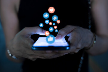 Young women use the phone to communicate at dusk, Social media concept.