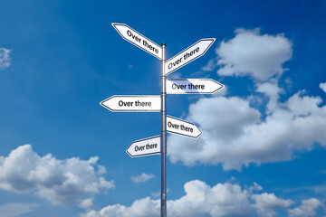 signpost with 6 arrow-shaped signs each with the words OVER THERE in different directions in front of a cloudy sky
