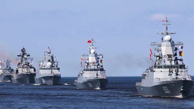 A line ahead of modern russian military naval battleships warships with submarine in the row, northern fleet and baltic sea fleet, summer sunny day, vibrant image
