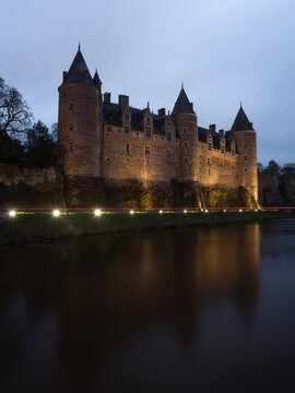 Nighttime panorama reflection of medieval Castle Chateau de Josselin in river Oust Morbihan Brittany France Europe