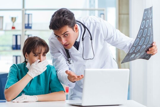 Two doctors discussing x-ray MRI image in hospital