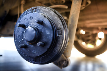 A rear hub of the car after removing a tire and wheel, maintaining a brake and wheel system, car jack-up for change a car wheel, Close-up shot