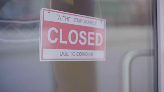 Closed For Business Due To Covid. Small Shop Puts Closed Sign Up On Storefront