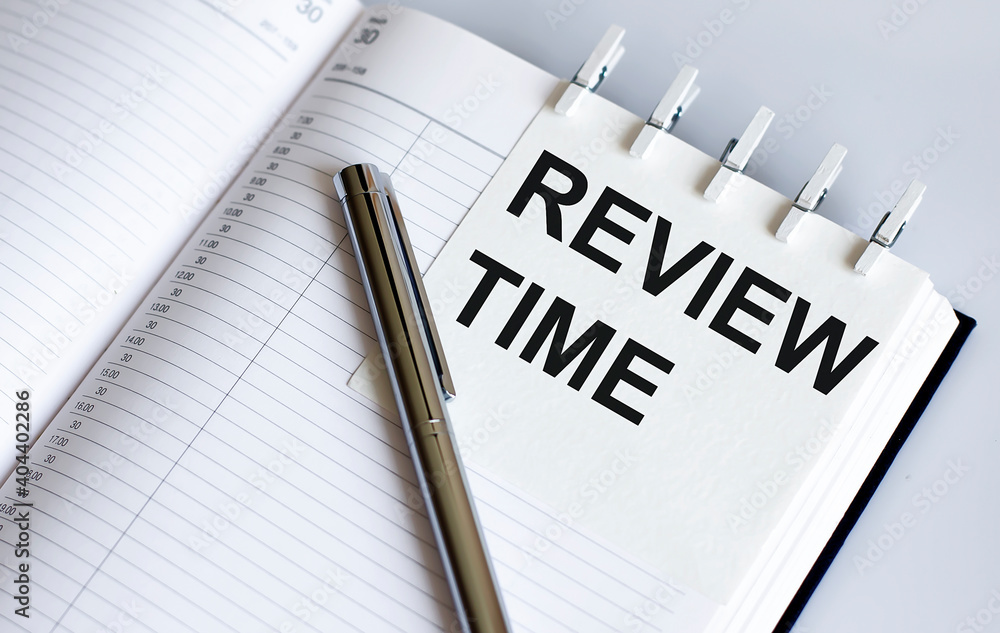 Poster text review time on the short note texture background with pen