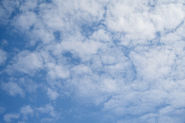 Blue sky with white clouds in daylight for background.