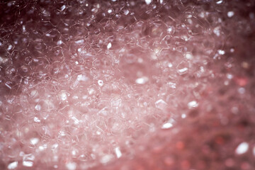 Close up macro shot of red soap foam, selective focus. 
