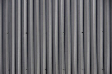 Full frame close-up view of a segment of the metal siding of a warehouse building