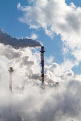 vertical banner with industrial chimneys with heavy smoke causing pollution on the blue sky background