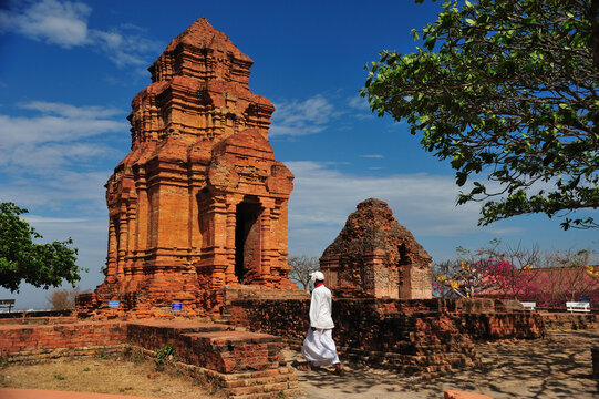 A man dress in traditional cham is walking into Thap Po Sah Inu temple, 15th century Cham tower ruins at Phan Thiet, Binh Thuan Province, Vietnam