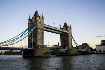 Fototapeta na wymiar The Tower Bridge was built in 1894 over the River Thames and is a drawbridge, rising for larger boats to pass under it hundreds of times a year. In its origin, the bridge was built by steam engines...