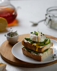 Breakfast with avocado sandwich and chopped poached egg