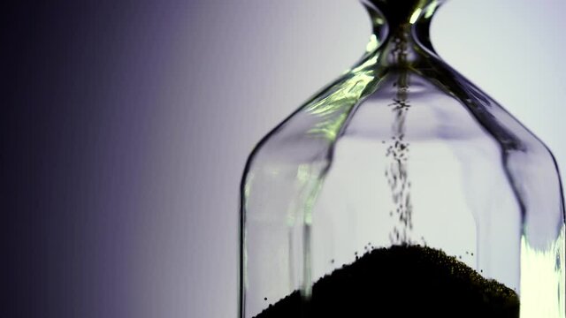 Hourglass as time passing concept for business deadline, urgency and running out of time.
