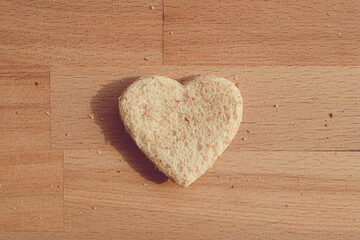 Grained bread cut off as heart shape. Concept of love and care in Valentine day.