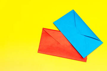 blue and red envelopes on yellow background.space for text