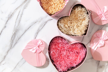 Empty beautiful gift boxes in the form of hearts for Valentine's Day, Birthday and Mother's Day. Marble background.