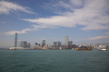 View of Victoria Harbor Skyline under blue sky in Hong Kong