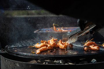 A professional cook prepares shrimps