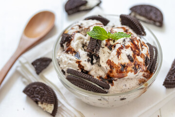 Chocolate cookie and ice cream in a glass bowl with mint leaf on white wooden background, summer sweet and dessert