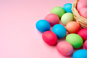 Painted Easter eggs on pink background top view