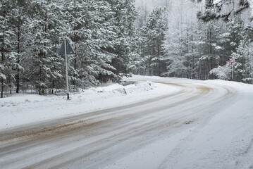 A winding road in a winter forest. Snow, winter, forest, trees. New Year, Christmas. Time of year.