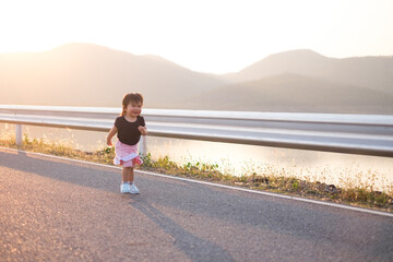 thailand child running on the way with sunset ,wintage tone