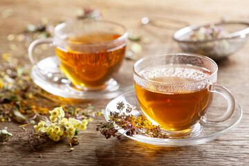 Cups of herbal tea with dried herbs