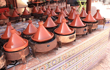 Cooking of meat in traditional Moroccan ceramic tajine dish, Morocco