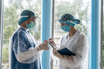 Work in the clinic. Healthcare workers with test tubes with blood record the result of the test