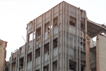 Crumbling emergency skeleton of destroyed building with broken windows for demolition