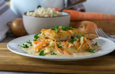 Pan fried fish with brown rice, vegetable and bechamel sauce